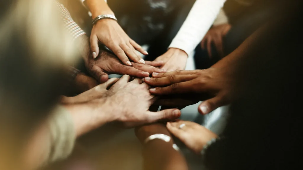 A group of people with their hands together